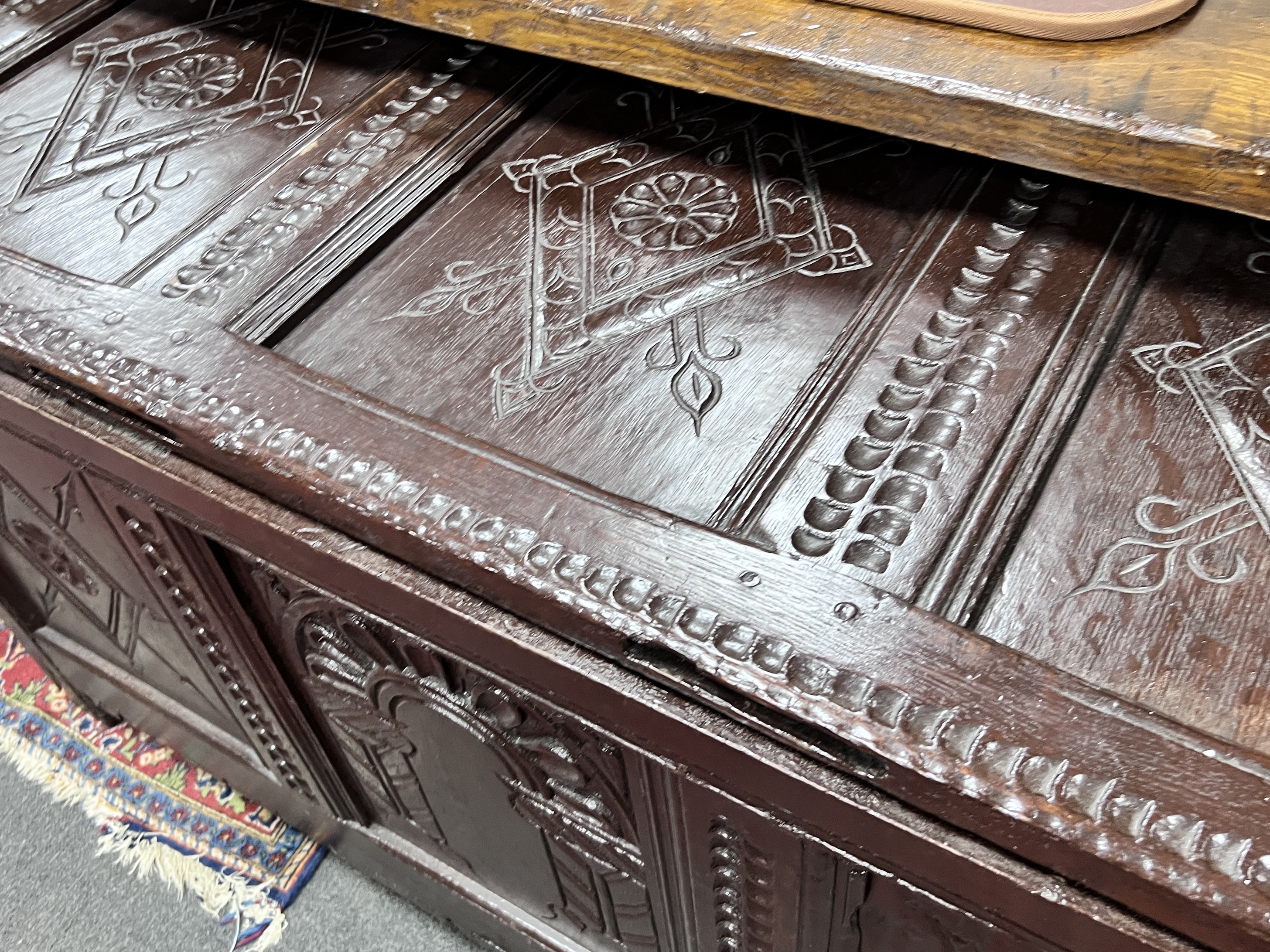 A 17th century later carved oak coffer, width 132cm